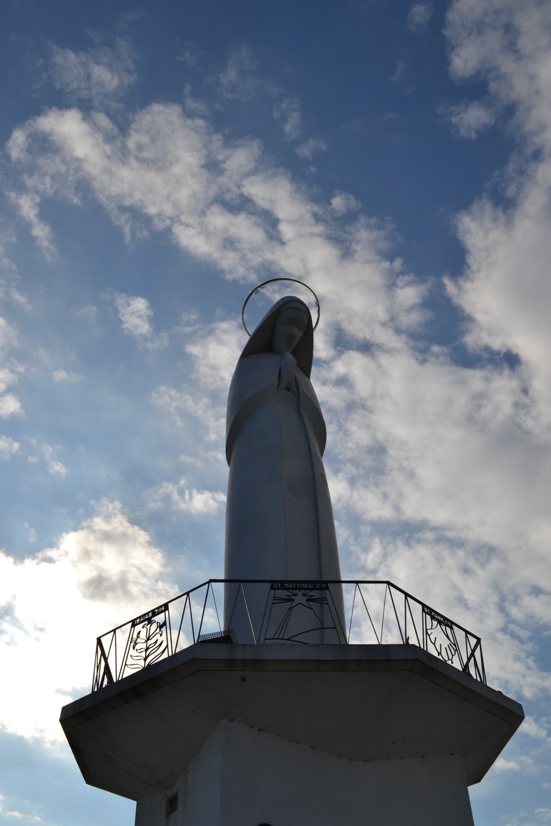 A statue of the Virgin Mary, her head bowed and hands reposed in prayer. The statue faces the riverfront in the township of Portage de Sioux, MO.