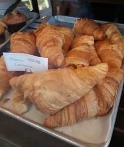 Croissants in a glass bakery case